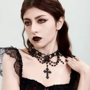 Black steampunk gothic cross choker necklace with layered beads and engraved pendant worn by female model in studio close-up