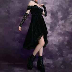 Gothic black velvet high-low dress with lace sleeves and platform boots, side three-quarter view