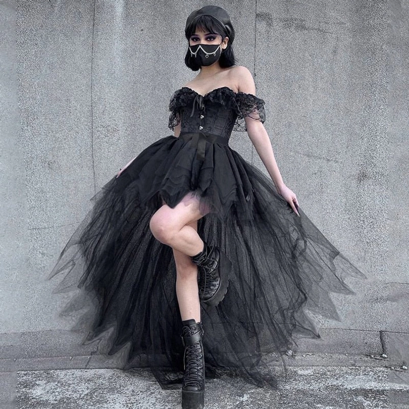 Black gothic high-low tulle steampunk skirt with empire waist, styled with off-shoulder corset top and ruffled trims, worn by short-haired model against concrete wall backdrop