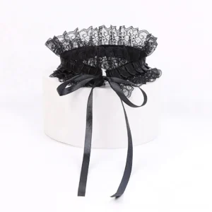 Black lace neck collar flat lay display showing ruffled lace edges and long satin tie straps with bow knot detail, steampunk Victorian choker accessory