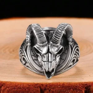 Gothic ram skull ring frontal view displaying detailed skull carving and ornate scroll patterns on ring shoulders