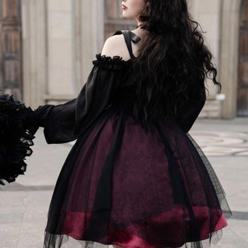 Back view of gothic off-shoulder steampunk lolita dress displaying long dramatic puff sleeves, layered tulle construction, dark wine red inner lining, and vintage stone courtyard backdrop