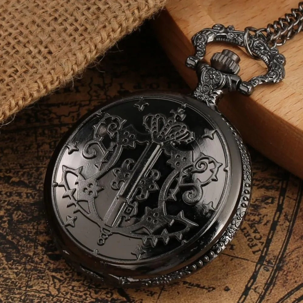 Gothic steampunk pocket watch back side with embossed patterns and ornate chain attachment, gun-black metal finish displayed on vintage map and burlap background