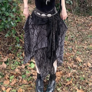Gothic steampunk skirt with tree branch pattern and lace trim paired with leather boots, front partial view on forest foliage background