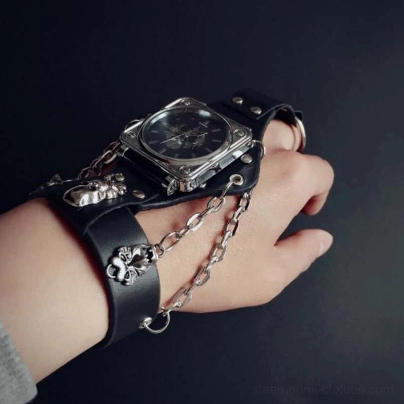 Three-quarter angle view of gothic steampunk watch with dark dial, silver skull decor, black leather band, and chain details on minimal background