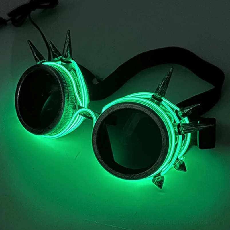 Green LED steampunk goggles with glowing EL wire trim and metal spikes on dark green luminous studio background