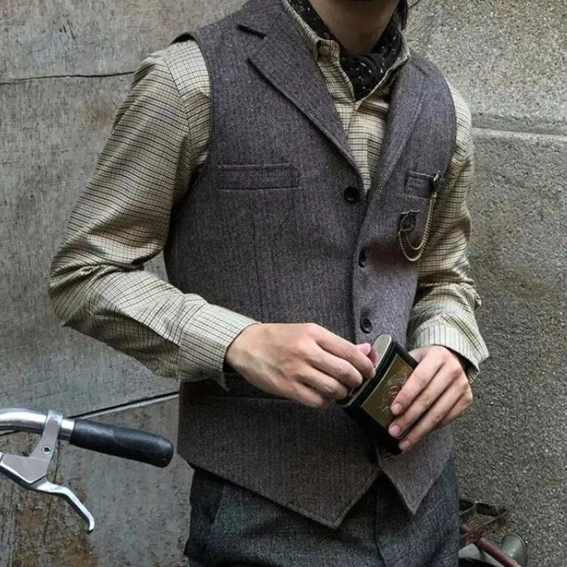 Vintage grey herringbone tweed waistcoat with pocket watch strap loop, right three-quarter view with bicycle