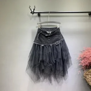 Dark gray denim and layered tulle steampunk skirt with frayed waistband and irregular hem, front view - industrial punk fashion