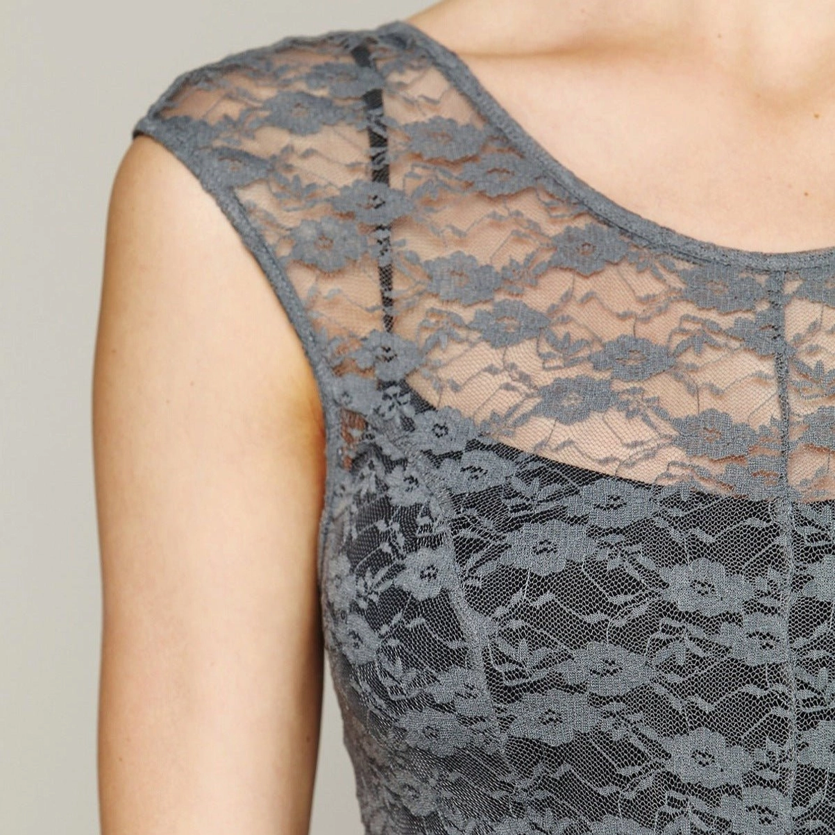 Close-up detail of floral lace texture and sheer cap sleeves on steampunk dress