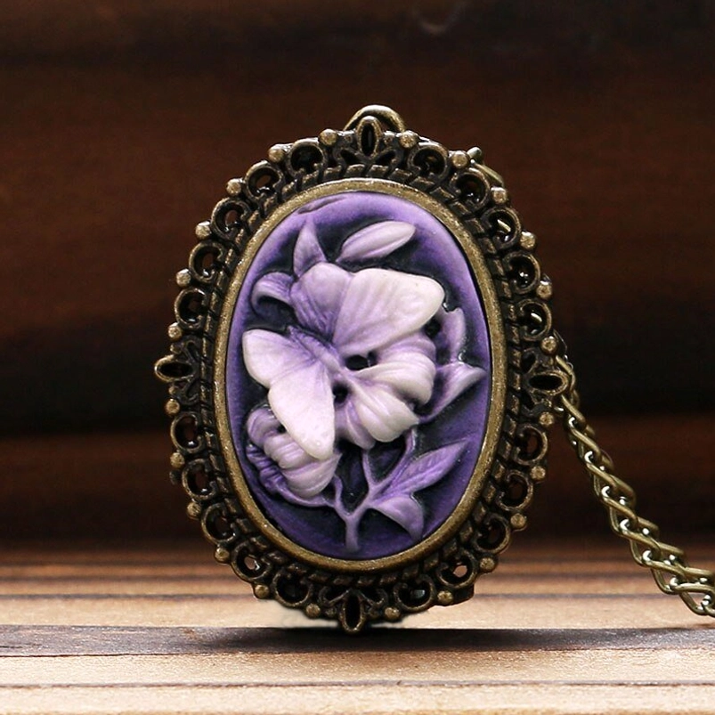 Oval lilac cameo pendant with ornate bronze filigree frame - detailed front view of steampunk watch necklace