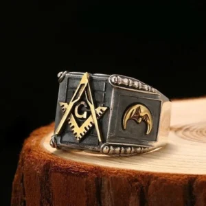 Vintage Masonic signet ring front three-quarter view with crescent moon decoration and embossed borders on wooden display