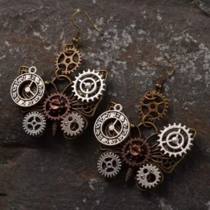 Mechanical steampunk butterfly earrings displayed on dark spotted stone background, featuring antique bronze mixed metal parts with ornamental gear accents