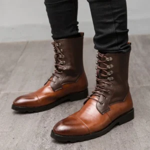 Men's steampunk lace-up combat boots front three-quarter view showcasing gradient two-tone brown split leather, reinforced metal lace eyelets, polished cap toe design, and durable non-slip rubber outsole