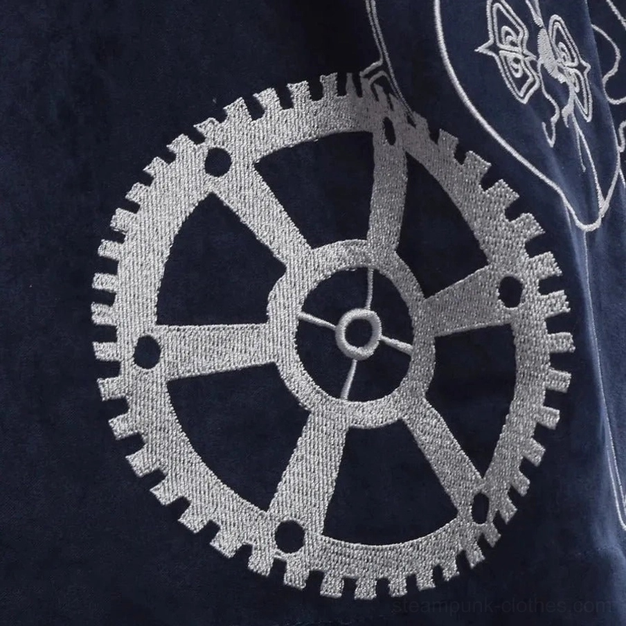 Gear embroidery detail of navy steampunk dress showing silver mechanical gear embroidered pattern on navy suede fabric, highlighting artistic craftsmanship