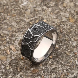 Viking rune decorative steampunk ring top view displaying intricate carved symbols and weathered dark finish on textured surface