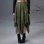 Olive green asymmetrical steampunk skirt front view with handkerchief hem and lace overlay panels, styled with black cropped top and combat boots
