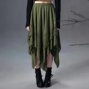 Olive green asymmetrical steampunk skirt front view with handkerchief hem and lace overlay panels, styled with black cropped top and combat boots