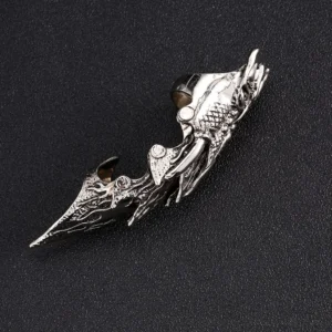 Close-up detailed view of articulated steampunk owl finger armor highlighting the hand-engraved sculpted owl head crown, segmented articulated joints, intricate flame texture patterns, and mechanical precision craftsmanship on black background