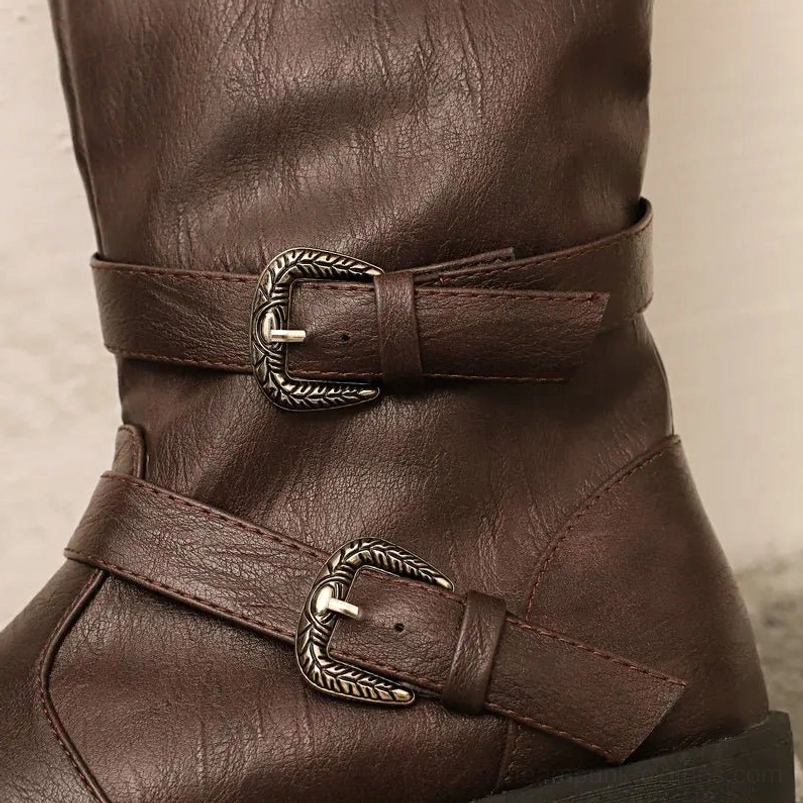 Close-up detail of steampunk pirate boot showing textured faux leather material and ornate metal buckle hardware