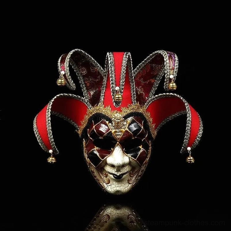 Red, gold and black Venetian jester steampunk masquerade mask with checkered eye masks, bell-adorned jester caps, and weathered cracked texture - frontal studio shot