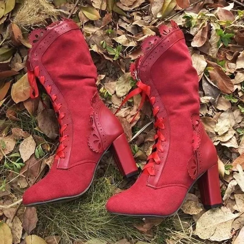 Pair of red steampunk mid-calf boots with lace-up front and scalloped decorative trims, top-down view showing boot construction