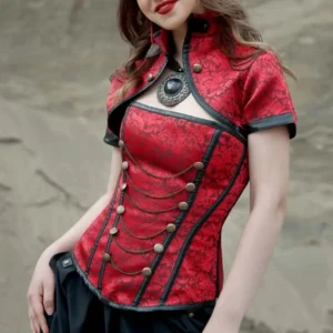 Red steampunk corset with detachable bolero, brass buttons and chain details on model outdoors