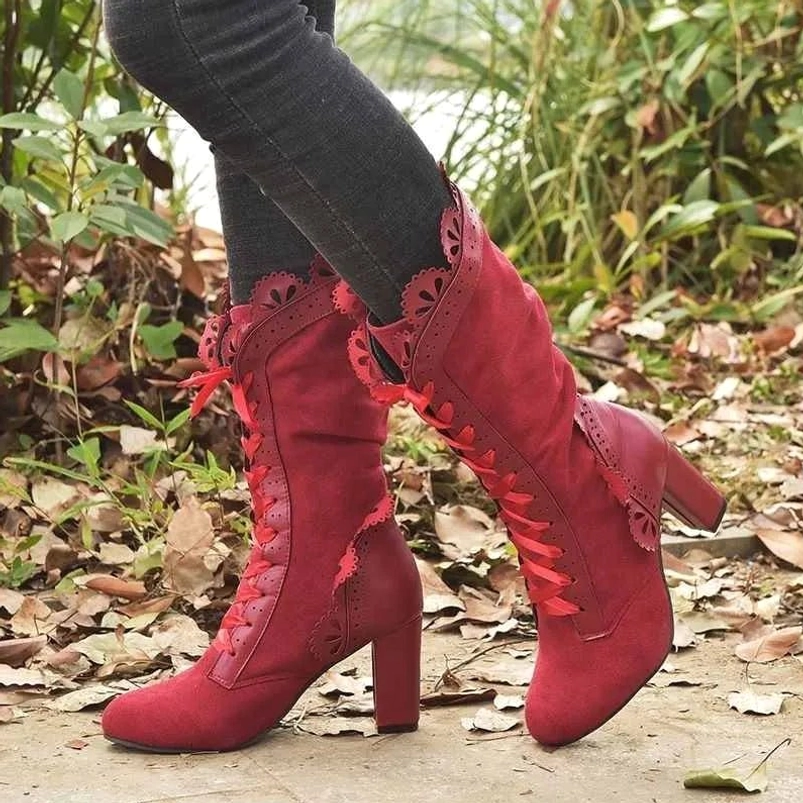 Red suede steampunk lace-up boots with satin ribbon laces and block heel, mid-calf height Victorian-inspired design worn outdoors