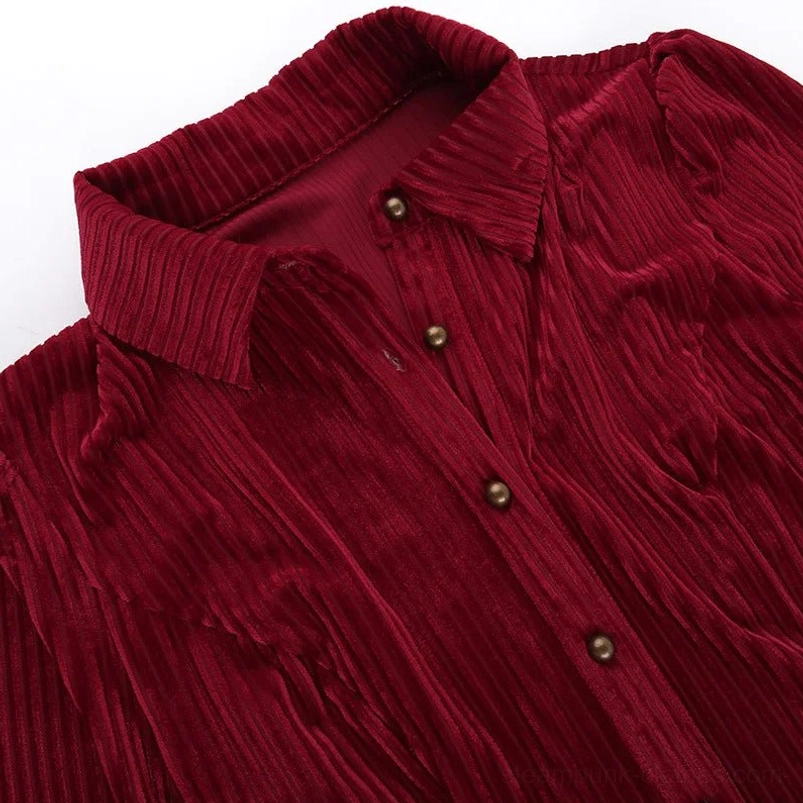 Red velvet steampunk shirt close-up detail showing vertical ribbed texture and bronze button detailing