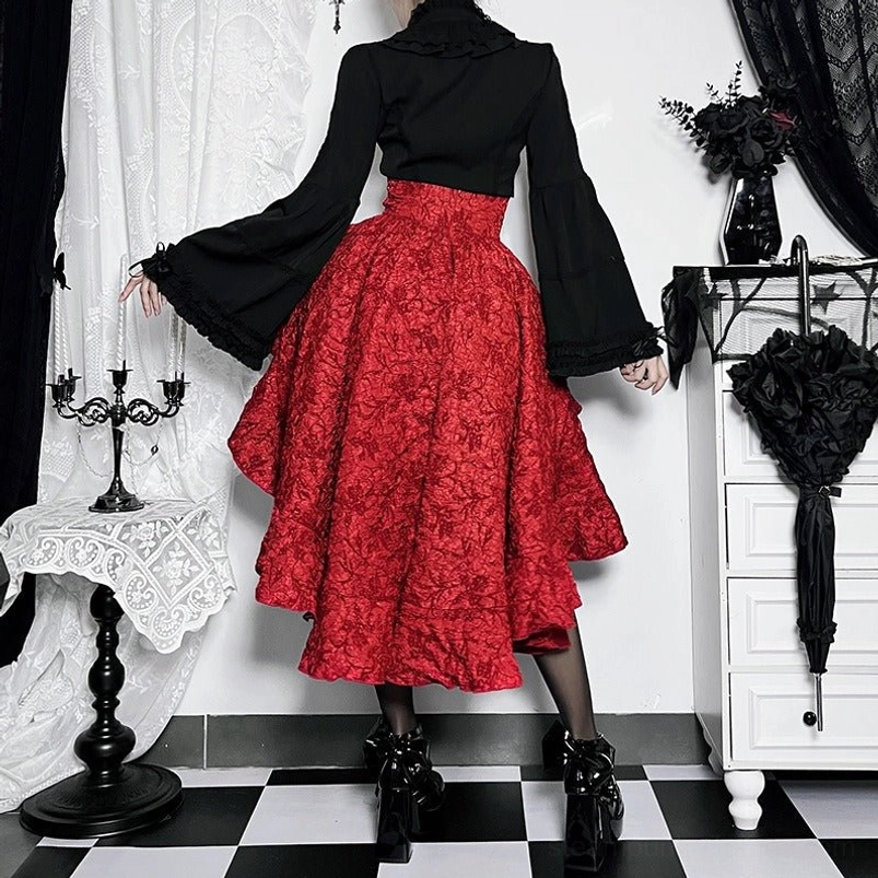 Red steampunk high-low skirt rear view showing long jacquard hem length, layered ruffle construction, and back silhouette with platform heels and bell-sleeve top