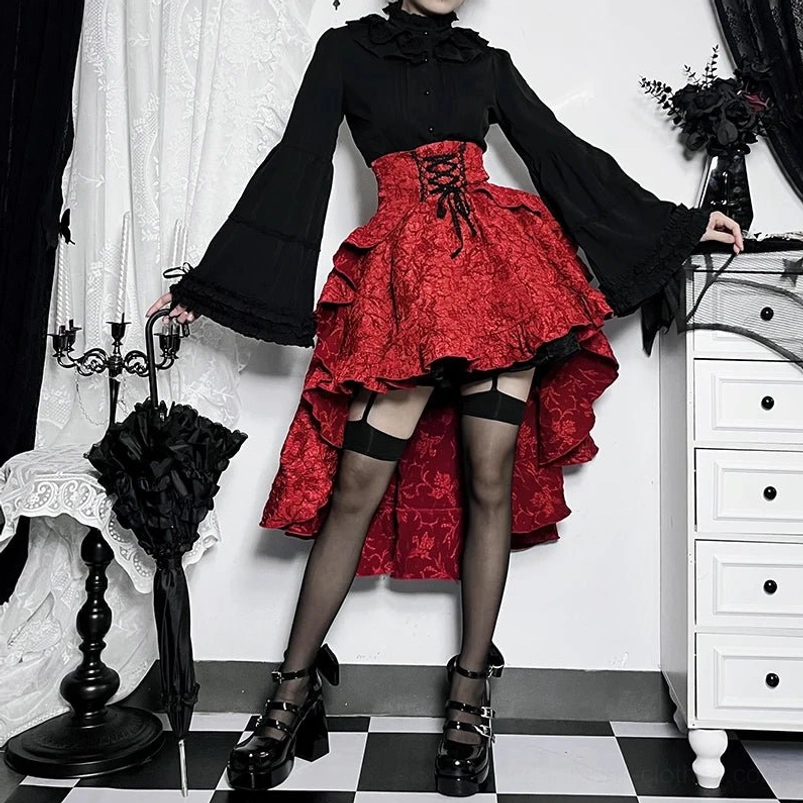 Red steampunk skirt outfit styling with black bell-sleeve blouse, platform buckle shoes, and black umbrella accessory, front eye-level view in gothic studio setting