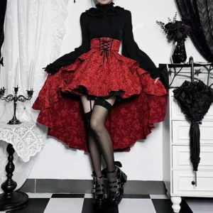 Red steampunk high-low skirt with layered ruffles and corset-style waistband on model, front low-angle view showcasing jacquard fabric texture and dramatic hem