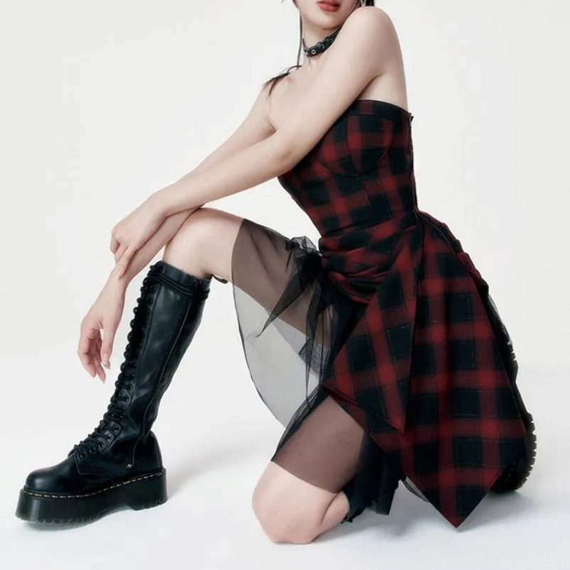 Red and black tartan steampunk dress side profile showing sheer black tulle panel detail, paired with lace-up combat boots - alternative fashion styling