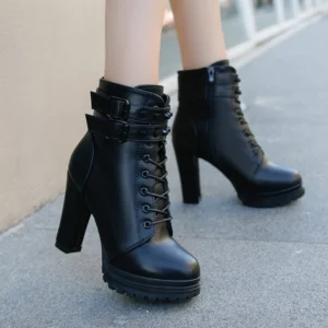 Steampunk ankle boots side profile showing side zipper, studded buckle decoration, and industrial block heel design