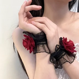 Lolita wrist cuffs pair on model showing black elastic ruffled mesh and twin wine-red rose decorations side angle upper body view