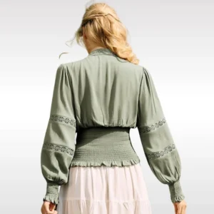 Sage green steampunk blouse back view showing smocked ruffled hem and lace sleeve decorations