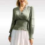 Sage green steampunk blouse front view with V-neck lace trim and lantern sleeves worn by female model