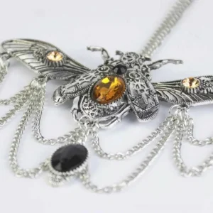 Silver steampunk beetle pendant necklace flat lay showing detailed gear engravings and cascading chain tassels with gemstones