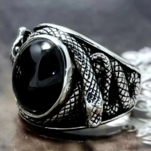 Close-up front view of coiled silver snake steampunk ring design highlighting serpent head details, black oval gem accent, and intricate surface engravings with gothic aesthetic
