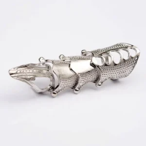 Silver steampunk finger armor ring side view showing interlocking articulated segments with dotted texture and geometric hollow openings