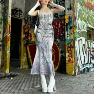 Skeleton print fishtail steampunk maxi slip dress front view with graffiti backdrop and white platform boots