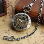 Skeleton steampunk pocket watch with ornate bronze floral frame and exposed mechanical gears, displayed on vintage map with leather notebook and wooden box, three-quarter overhead view showing intricate movement details
