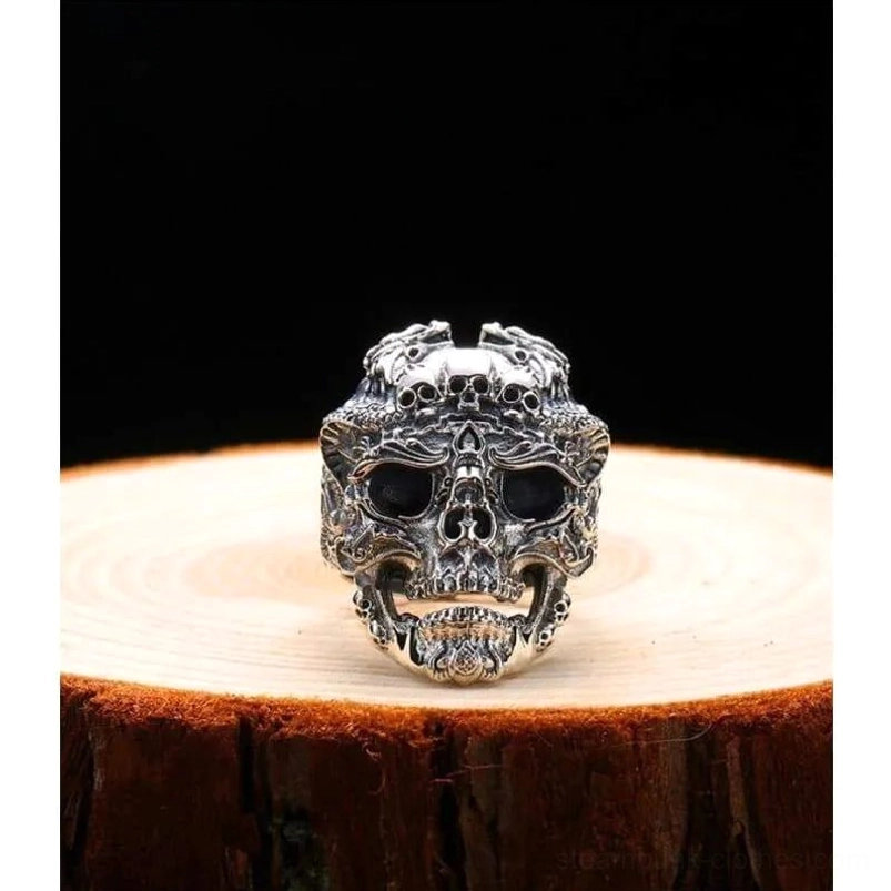 Skull dragon steampunk ring front direct view - gothic dual skull design with hollowed eye sockets and aged silver metal texture