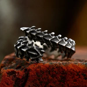 Spinalis skeleton bone ring side profile displaying aged dark metal with sharp spinal protrusions and adjustable open shape