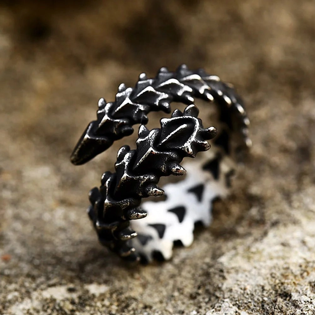 Spinalis reptile spine wrap ring overhead angle showing black exterior with white triangular inner pattern and spiked bone design