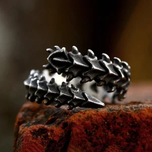 Spinalis vertebrae steampunk ring three-quarter view showing matte black vintage finish with serrated spine texture and open wrap design