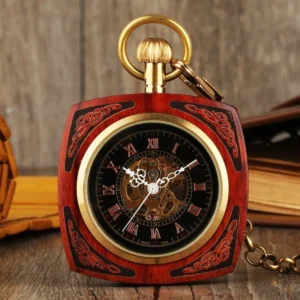 Red wooden square steampunk pocket watch with brass trim and skeleton Roman numeral dial, front overhead view showing carved scroll details