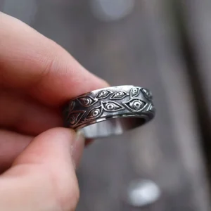 All-seeing eye engraved steampunk ring worn on finger - vintage silver finish with detailed carved eye motifs, front close-up
