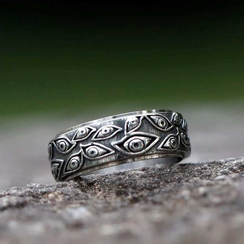 Rotatable spinner steampunk ring with intricate all-seeing eye carvings - titanium steel construction outdoor setting