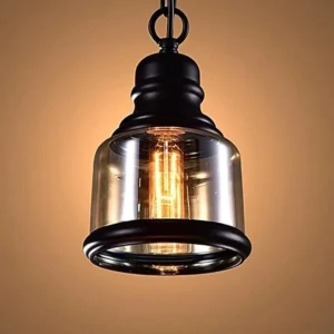 Single amber steampunk pendant light with cylindrical glass shade in studio lighting, showing front-facing industrial design