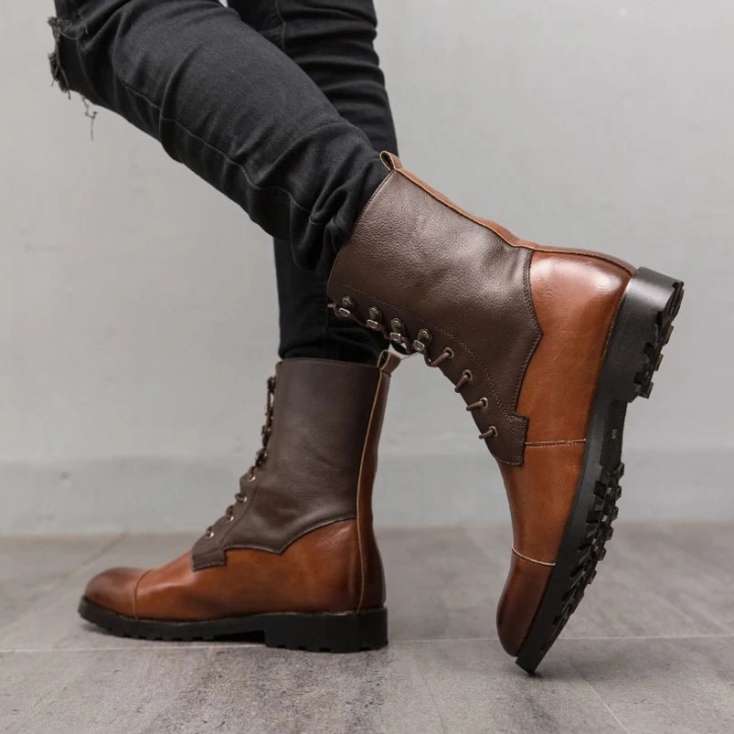 Steampunk ankle combat boots side view displaying two-tone leather upper construction, visible stitching detail echoing Victorian craftsmanship, industrial-grade outsole with superior grip, paired with black ripped denim